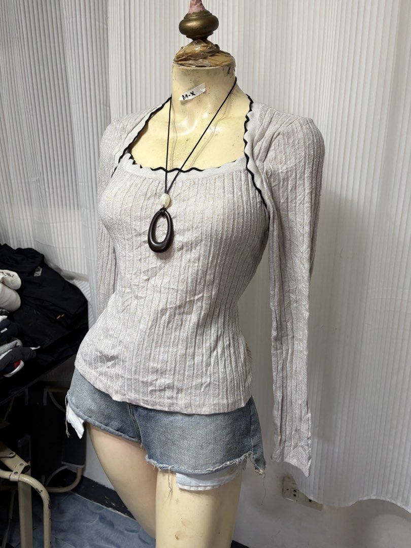 Shein Beige Ribbed Square Neck Long Sleeve Top (Category: Longsleeves) located in General Trias. Submitted by crissy9053136 (Listing ID 1470229242, Image 2). Description: - Brand: Shein - Size: L - Color: Beige with black contrast trim - Design: Square neckline, long sleeves, fitted silhouette - Details: Lettuce edge trimming on neckline - Material: Stretchy, super comfortable ribbed knit - Condition: Great basic for everyday wear.