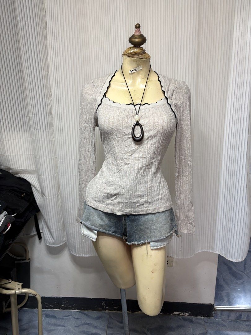 Shein Beige Ribbed Square Neck Long Sleeve Top (Category: Longsleeves) located in General Trias. Submitted by crissy9053136 (Listing ID 1470229242, Image 1). Description: - Brand: Shein - Size: L - Color: Beige with black contrast trim - Design: Square neckline, long sleeves, fitted silhouette - Details: Lettuce edge trimming on neckline - Material: Stretchy, super comfortable ribbed knit - Condition: Great basic for everyday wear.