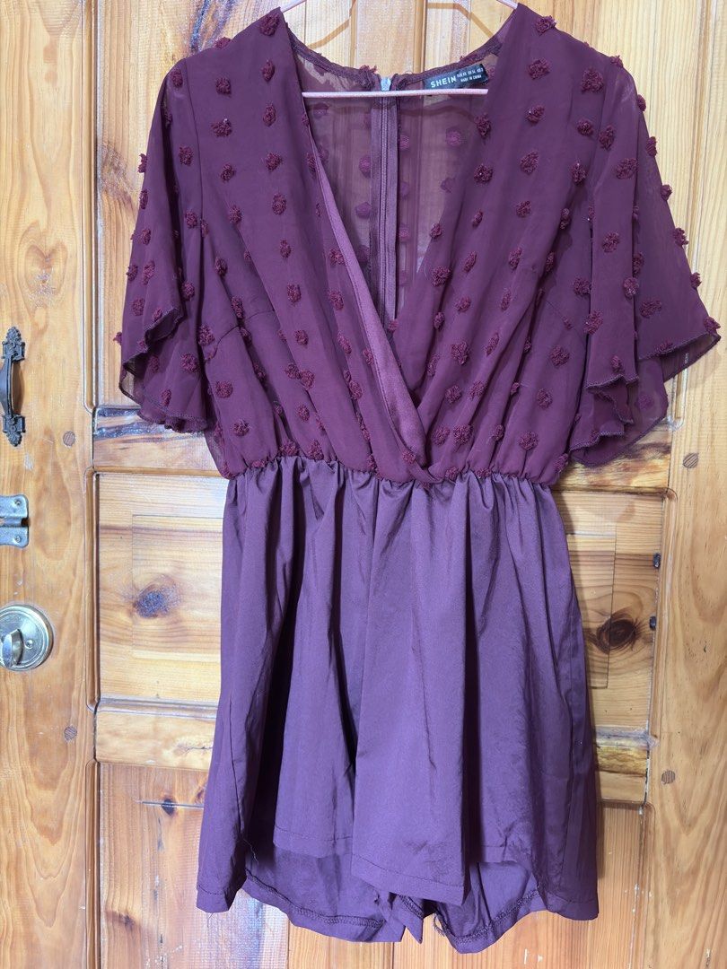 SHEIN Burgundy Dot Chiffon Romper Size XS (Category: Rompers) located in Baguio. Submitted by declutterbycys (Listing ID 1470180320, Image 1). Description: - Brand: SHEIN - Size: XS (EU 34, US 2) - Color: Burgundy - Design: V-neck crossover front with cute flutter sleeves - Details: Sheer dotted mesh top with back zip closure and solid lower half - Fabric: Lightweight and comfortable - Occasion: Perfect for casual outings or dates.