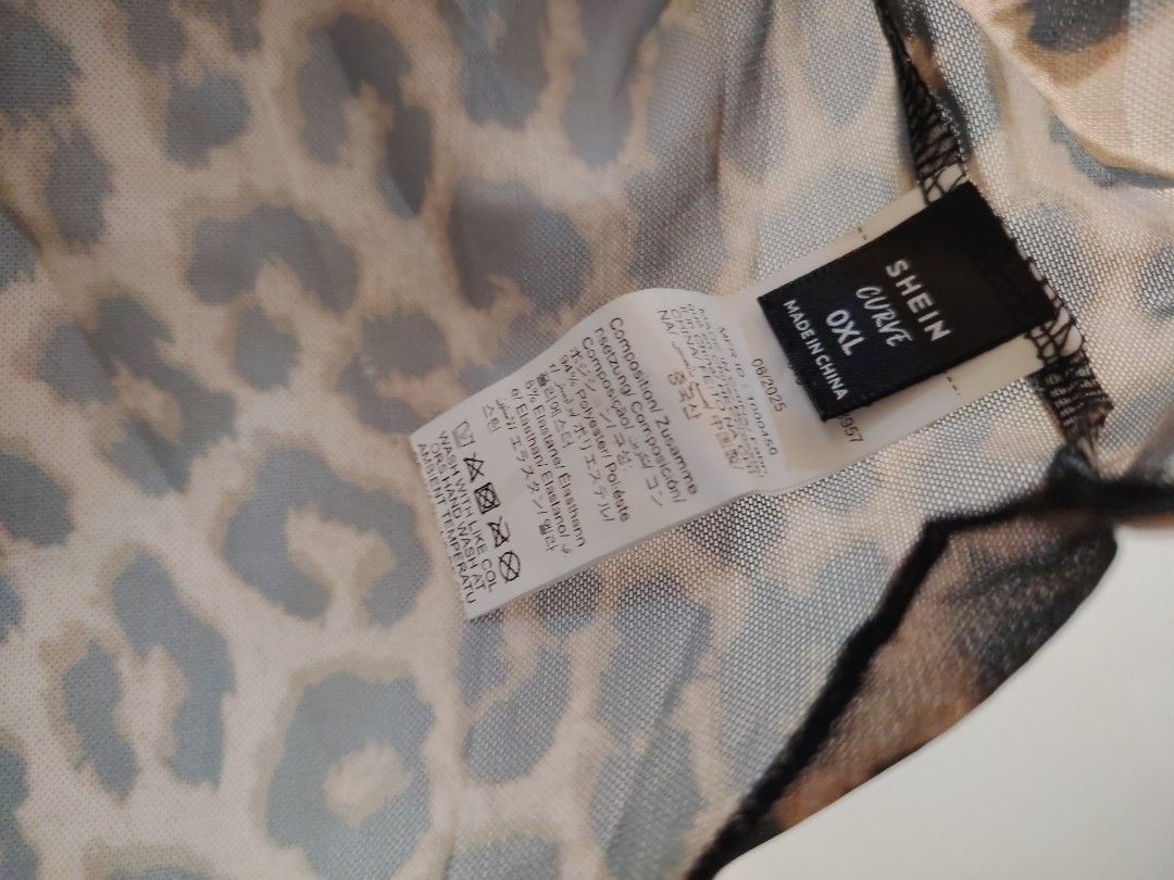 SHEIN Curve Leopard Print Mesh Tee Size 0XL (Category: Sleeveless) located in Manila. Submitted by babeboxtheory (Listing ID 1470295902, Image 3). Description: - Brand/Style: SHEIN Curve leopard print mesh top - Size: 0XL (tag attached) - Design: Short sleeves, round neckline, and trendy lettuce trim edges - Fabric: Sheer animal print mesh (94% polyester, 6% elastane) - Features: Lightweight, stretchy, and makes a great layering piece - Care: Han