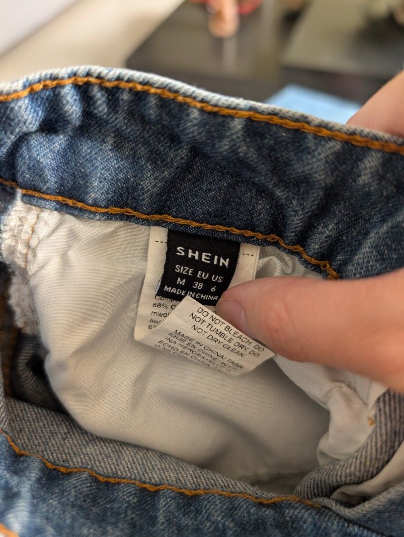 SHEIN Denim Midi Skirt Size M (Category: Skirts) located in Paranaque City. Submitted by clothingarchives (Listing ID 1470164055, Image 3). Description: - Brand: SHEIN - Style: Denim midi skirt with front split hem - Color: Medium wash blue - Size: Medium (EUR 38, US 6) - Material: 88% cotton, 6% polyester, 6% viscose - Features: Front button & zip closure, belt loops, front pockets, and back patch pockets.