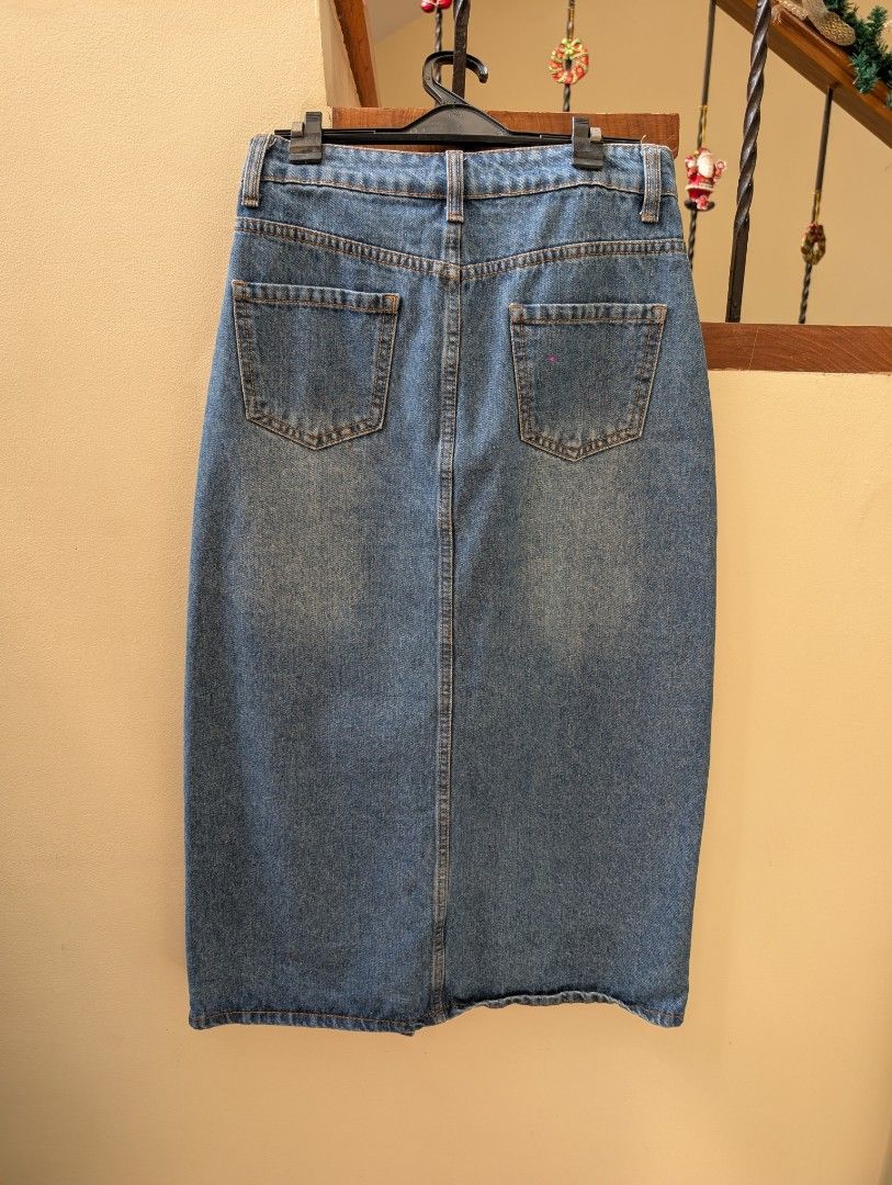 SHEIN Denim Midi Skirt Size M (Category: Skirts) located in Paranaque City. Submitted by clothingarchives (Listing ID 1470164055, Image 2). Description: - Brand: SHEIN - Style: Denim midi skirt with front split hem - Color: Medium wash blue - Size: Medium (EUR 38, US 6) - Material: 88% cotton, 6% polyester, 6% viscose - Features: Front button & zip closure, belt loops, front pockets, and back patch pockets.