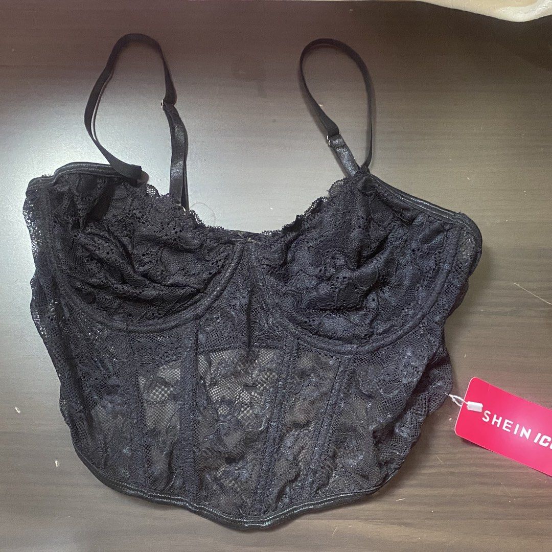 Shein Icon Black Lace Corset Top (Category: Sleeveless) located in Navotas City. Submitted by allsaledecluttering (Listing ID 1470178537, Image 2). Description: - Brand: Shein Icon - Color: Black - Condition: Brand new with original pink store tag attached - Material/Design: Sheer floral lace with scalloped edges and curved hemline - Features: Built-in boning structure (front and back) and adjustable straps - Style: Great for layering or going ou