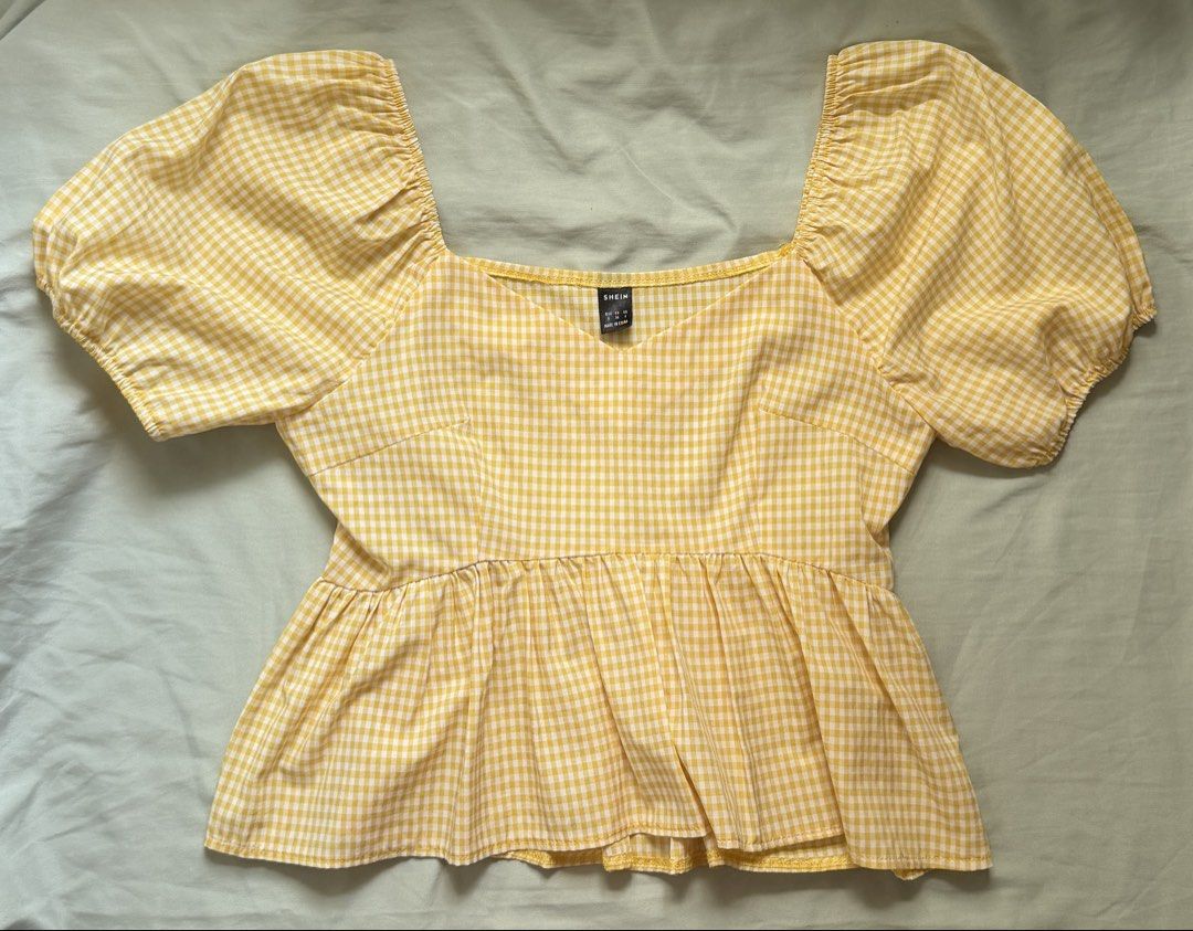 SHEIN Yellow Gingham Peplum Blouse (Category: Blouses) located in Dinalupihan. Submitted by wonmeoww (Listing ID 1470250223, Image 1). Description: - Brand: Shein - Design: Yellow and white checkered pattern - Details: Square neckline, short puff sleeves, and ruffled hem - Closure: Convenient side zipper - Fit: Fitted bodice with a flared waist - Condition: Excellent / Like new - Mode of Payment: GCash.