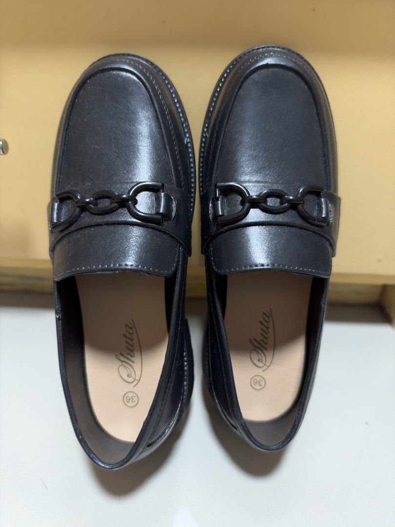 Shuta Black Chain Loafers Size 36 (Category: Loafers) located in Manila. Submitted by thrifty82 (Listing ID 1470151524, Image 1). Description: - Brand: Shuta - Size: EU 36 - Color: Classic Black (rubberized) - Style: Slip-on loafers with chic black chain detail - Design: Round toe with neat stitched edging - Condition: Excellent, clean uppers and insoles with minimal signs of handling - Perfect for work, school, or casual day-outs - Message me fo