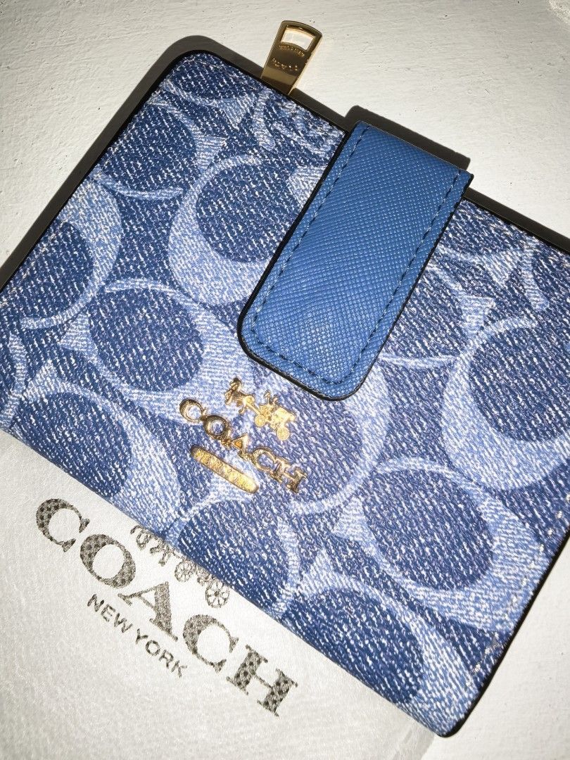 Signature small Wallet (Category: Luxury Bags & Wallets) located in Manila. Submitted by mysticfox.9b1678 (Listing ID 1470185190, Image 3). Description: - Design: signature print with solid leather trim - Hardware: Gold-tone hardware - Interior: Blue lining with multiple card slots - Closure & Pockets: Snap closure, side zip coin pocket - Size: Compact, ideal for mini bags - Condition: Clean overall condition - Inclusion: Matching dust bag includ