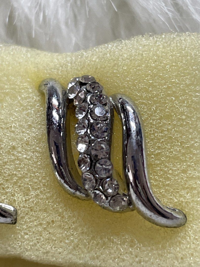 Silver Rhinestone Swirl Stud Earrings (Category: Earrings) located in San Juan City. Submitted by redrosierose (Listing ID 1470256497, Image 3). Description: - Silver-toned metal swirl earrings - Decorated with a center stripe of clear rhinestone crystals - Secure post back closure with butterfly backs - Modern curved design for a chic look - Versatile accessory for both daily wear and formal events - Clean condition, guaranteed no missing stones