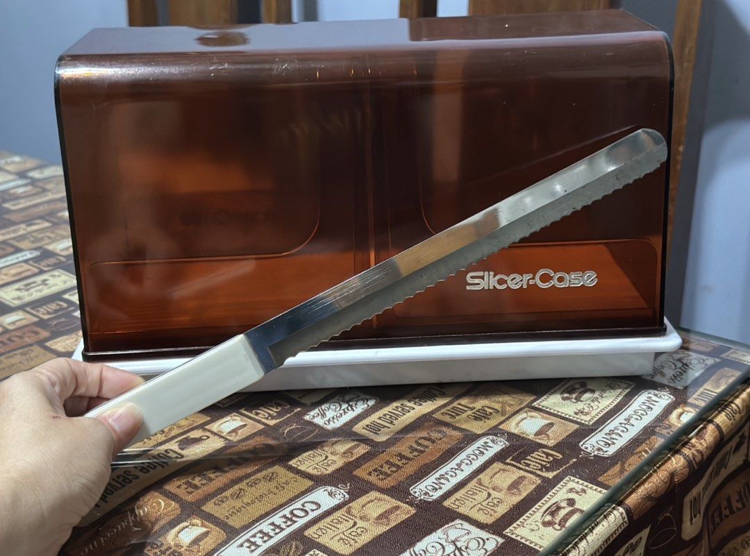 Slicer Case with Bread Knife Brown Amber Storage (Category: Knives & Chopping Boards) located in Mandaue City. Submitted by erin_grace (Listing ID 1470165539, Image 2). Description: - Retro vintage kitchen accessory in clean, ready-to-use condition - Includes a brown amber plastic cover and white base - Comes with a matching serrated bread knife with a white handle - Case safely stores the knife inside when not in use.