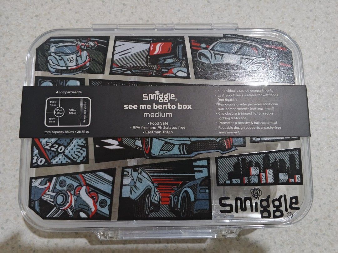 Smiggle See Me Bento Box Medium Race Car Design (Category: Babies & Kids Fashion) located in Lapu Lapu. Submitted by dawatkrist14304 (Listing ID 1470296523, Image 2). Description: - Brand new with original cardboard sleeve - Fun race car comic graphic design - 850ml total capacity with 4 individually sealed compartments - Removable divider for customizable lunch packing - Secure clip closure and hinged lid design - Food-safe, BPA, and phthalates-