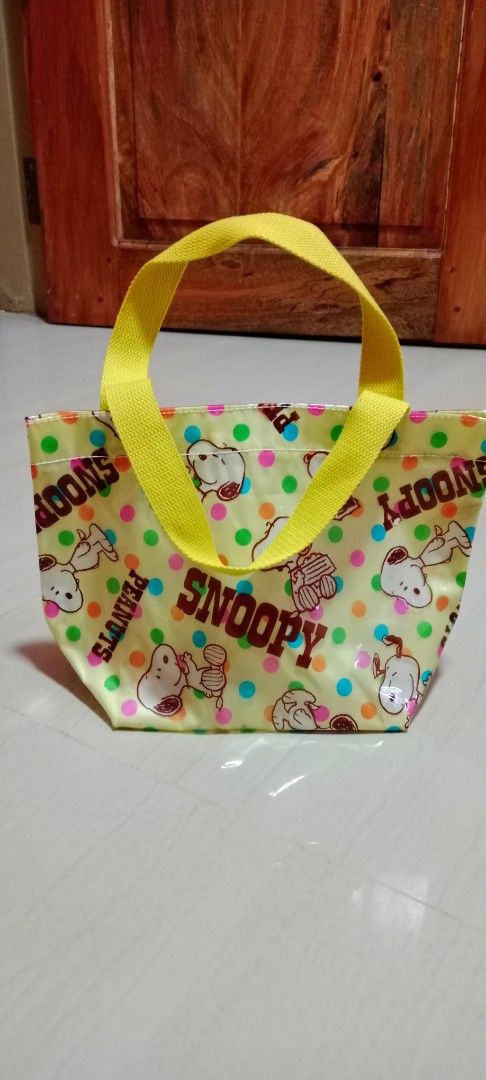 🇯🇵Snoopy Peanuts Yellow Polka Dot Tote Bag (Category: Tote Bags) located in Mangaldan. Submitted by closetqwin (Listing ID 1470202579, Image 3). Description: - Authentic Snoopy and Peanuts design - Cheerful yellow with colorful polka dots - Water-resistant shiny material - Gusseted sides for extra storage capacity - Durable bright yellow fabric handles - Perfect compact lunch bag or casual everyday tote.