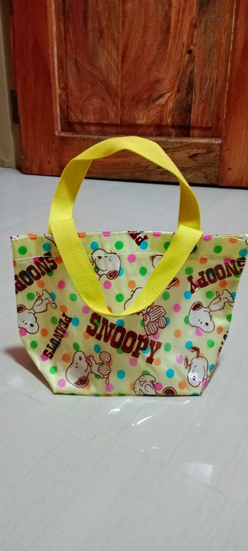 🇯🇵Snoopy Peanuts Yellow Polka Dot Tote Bag (Category: Tote Bags) located in Mangaldan. Submitted by closetqwin (Listing ID 1470202579, Image 2). Description: - Authentic Snoopy and Peanuts design - Cheerful yellow with colorful polka dots - Water-resistant shiny material - Gusseted sides for extra storage capacity - Durable bright yellow fabric handles - Perfect compact lunch bag or casual everyday tote.