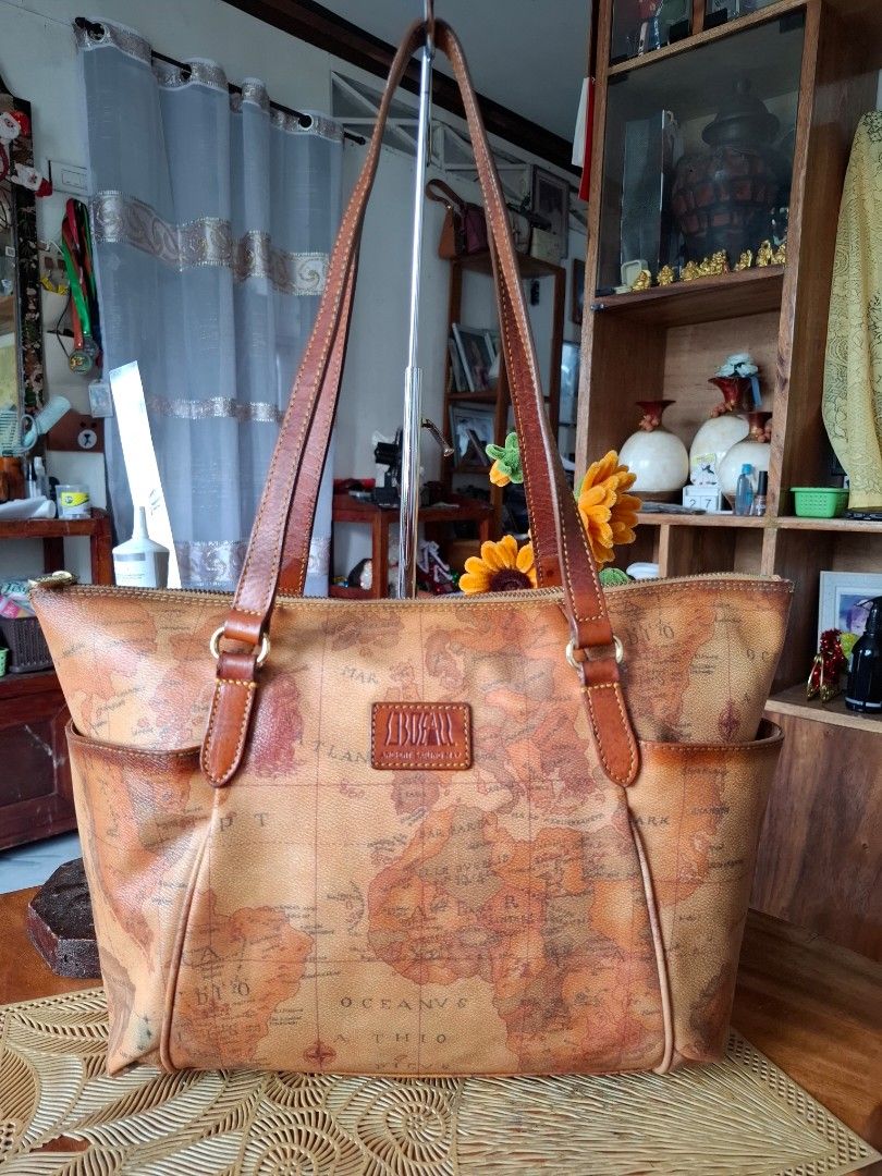 SOBDEAL Ancient Sailing Map Tote Bag (Category: Tote Bags) located in Libon. Submitted by jaladzarmi80045 (Listing ID 1470207211, Image 1). Description: - Authentic Sondeal tote bag - Eye-catching ancient sailing map print all over - Durable brown leather handles and trim with gold hardware - Secure zip top closure - Convenient external side pockets for quick access - Roomy interior, perfect as an everyday carryall.
