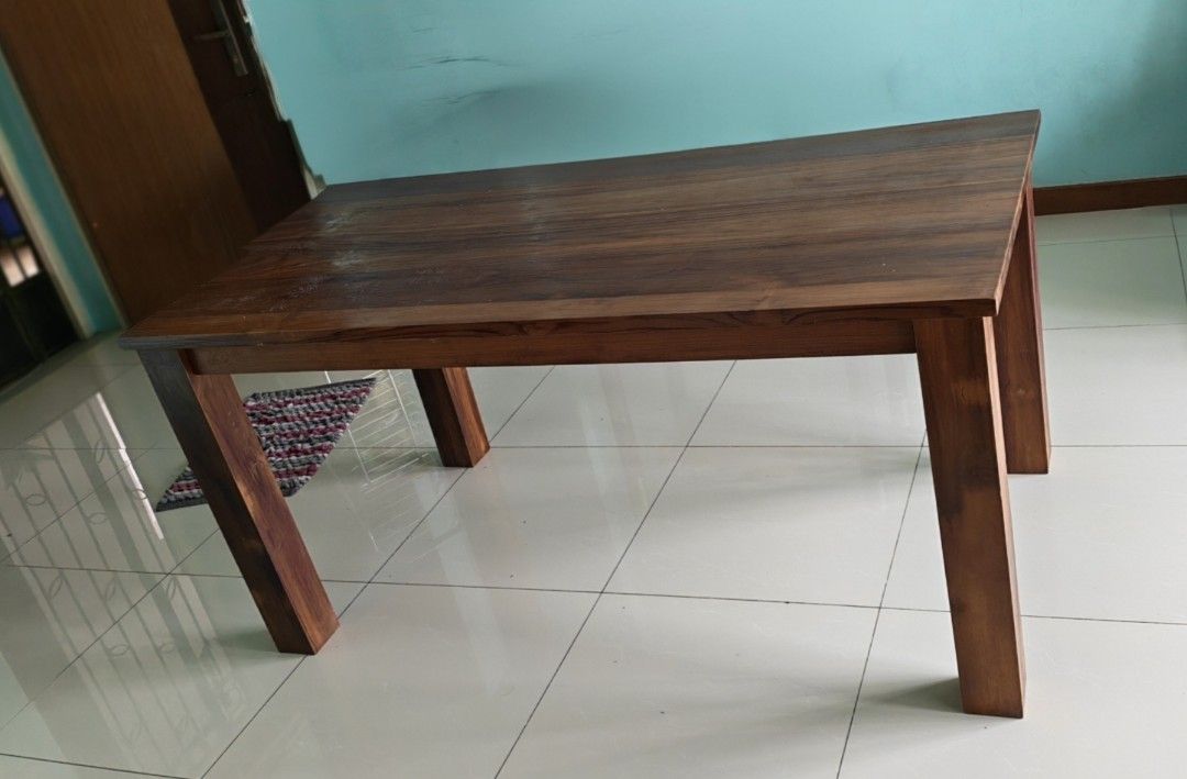 Solid Wood Rectangular Table (Category: Tables & Sets) located in Singapore. Submitted by palani.sg (Listing ID 1470165558, Image 2). Description: ***Self Collect*** - Material: Solid wood with rich brown grain finish - Design: Sturdy 4-leg construction, clean rectangular shape - Surface: Smooth with natural wood patterns - Use: Standard height dining or kitchen table - Condition: Well-maintained classic furniture piece.