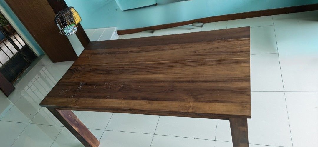 Solid Wood Rectangular Table (Category: Tables & Sets) located in Singapore. Submitted by palani.sg (Listing ID 1470165558, Image 3). Description: ***Self Collect*** - Material: Solid wood with rich brown grain finish - Design: Sturdy 4-leg construction, clean rectangular shape - Surface: Smooth with natural wood patterns - Use: Standard height dining or kitchen table - Condition: Well-maintained classic furniture piece.