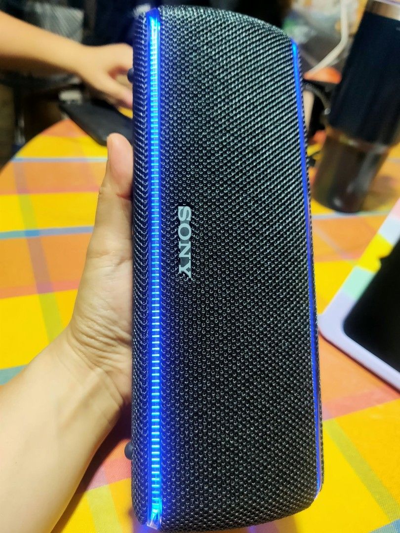 Sony SRS-XB31 Portable Wireless Bluetooth Speaker (Category: Soundbars, Speakers & Amplifiers) located in Manila. Submitted by jhs31 (Listing ID 1470308358, Image 3). Description: - Authentic Sony SRS-XB31 wireless speaker in sleek black - Built-in LED light strip with vibrant teal and blue glow - Durable mesh fabric exterior body - Secure rubber flap covering ports (micro-USB charging, audio-in, USB DC out) - Convenient top buttons for power, vo