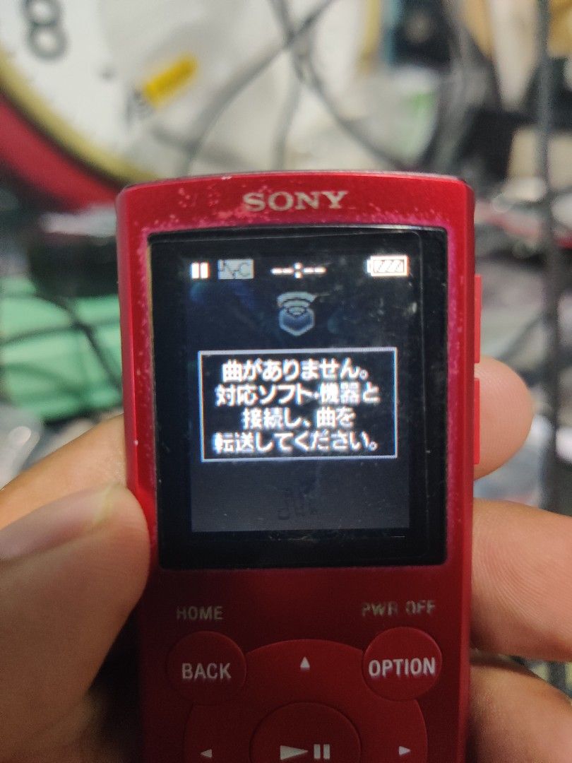 Sony Walkman NW-E062 Red Digital Music Player (Category: Portable Music Players) located in Quezon City. Submitted by bbert203 (Listing ID 1470199686, Image 2). Description: - Model: Sony Walkman NW-E062 (Red) - Compact, pocket-sized digital music player - Features a color screen and easy physical control buttons - Verified authentic with model and serial numbers on the back - Screen turns on and menus navigate normally - Shows typical wear marks