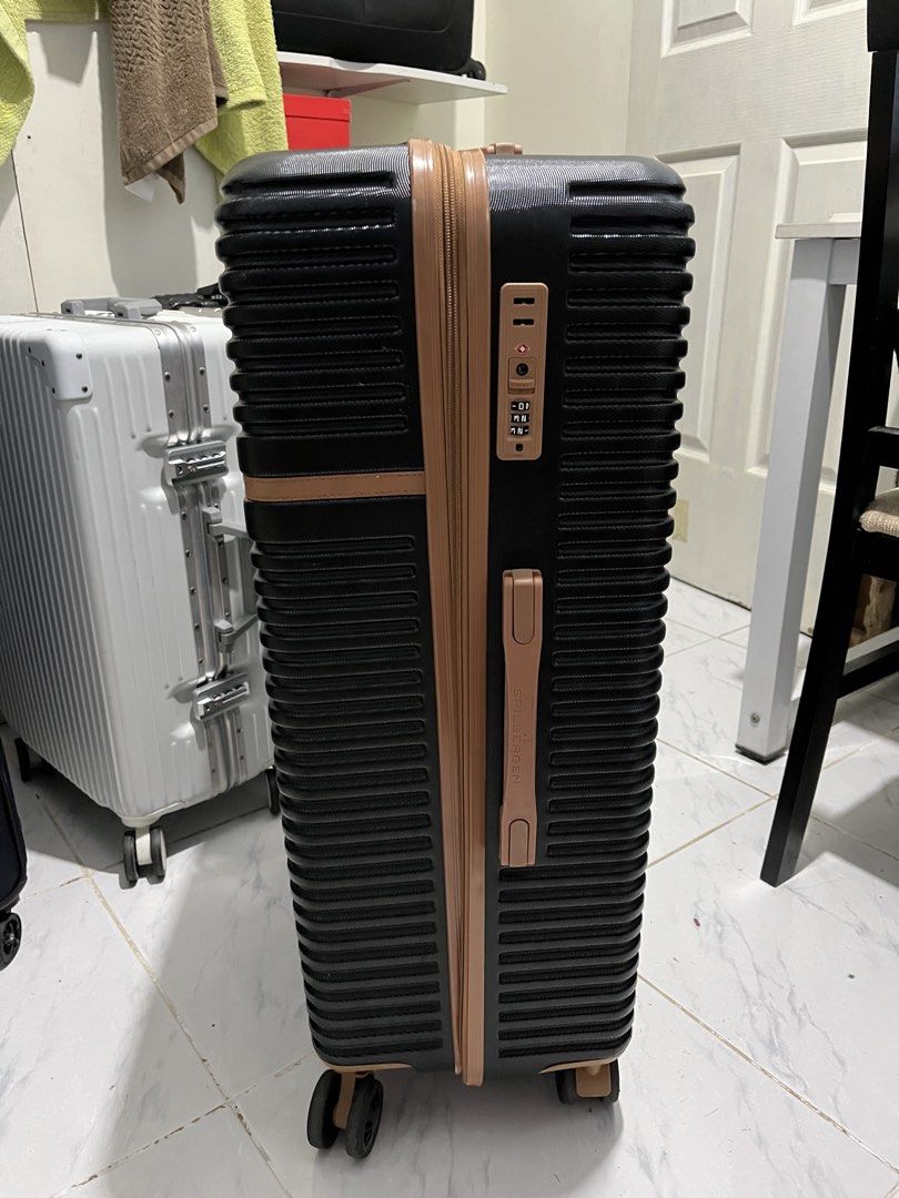 Spilbergen luggage (Category: Luggage) located in Marikina City. Submitted by patpatndls (Listing ID 1470271710, Image 2). Description: - Brand: Spilbergen - Type: Large hardcase luggage (Size 25-27) - Color: Black with stylish brown accents - Security: Built-in TSA lock for safe travel - Interior: Fully lined with branded Spilbergen fabric, cross straps, and zipped compartment - Mobility: Smooth-rolling multi-directional wheels - Condition: Well