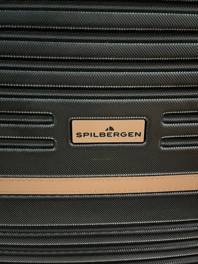 Spilbergen luggage (Category: Luggage) located in Marikina City. Submitted by patpatndls (Listing ID 1470271710, Image 3). Description: - Brand: Spilbergen - Type: Large hardcase luggage (Size 25-27) - Color: Black with stylish brown accents - Security: Built-in TSA lock for safe travel - Interior: Fully lined with branded Spilbergen fabric, cross straps, and zipped compartment - Mobility: Smooth-rolling multi-directional wheels - Condition: Well