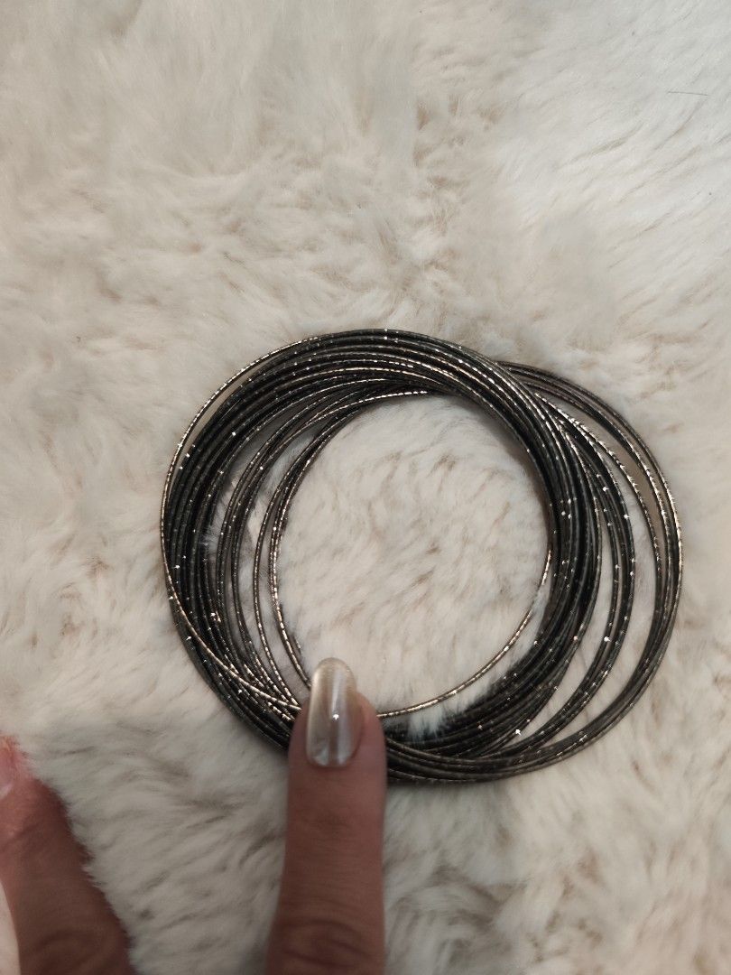 Stackable metallic thin bangles set (Category: Bracelets) located in Kuala Lumpur. Submitted by goldeneagle.7e7673 (Listing ID 1470160066, Image 1). Description: - Style: Multi-strand metal bangles with a textured sparkly finish - Color: Dark silver / gunmetal tone - Features: Lightweight, easy to slide on, perfect for stacking - Occasion: Great for everyday wear or a night out.