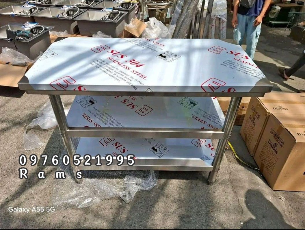 Stainless Steel Kitchen Preparation Table with Shelves (Category: Tables & Sets) located in Manila. Submitted by acykt18 (Listing ID 1470290577, Image 3). Description: - Heavy-duty SUS 304 stainless steel prep table - Ideal for commercial kitchens, restaurants, and food businesses - Multiple sizes available with 2 or 3 layers - Optional top shelves available - Durable, long-lasting, and brand new (protective film still on) - Send a message for sp