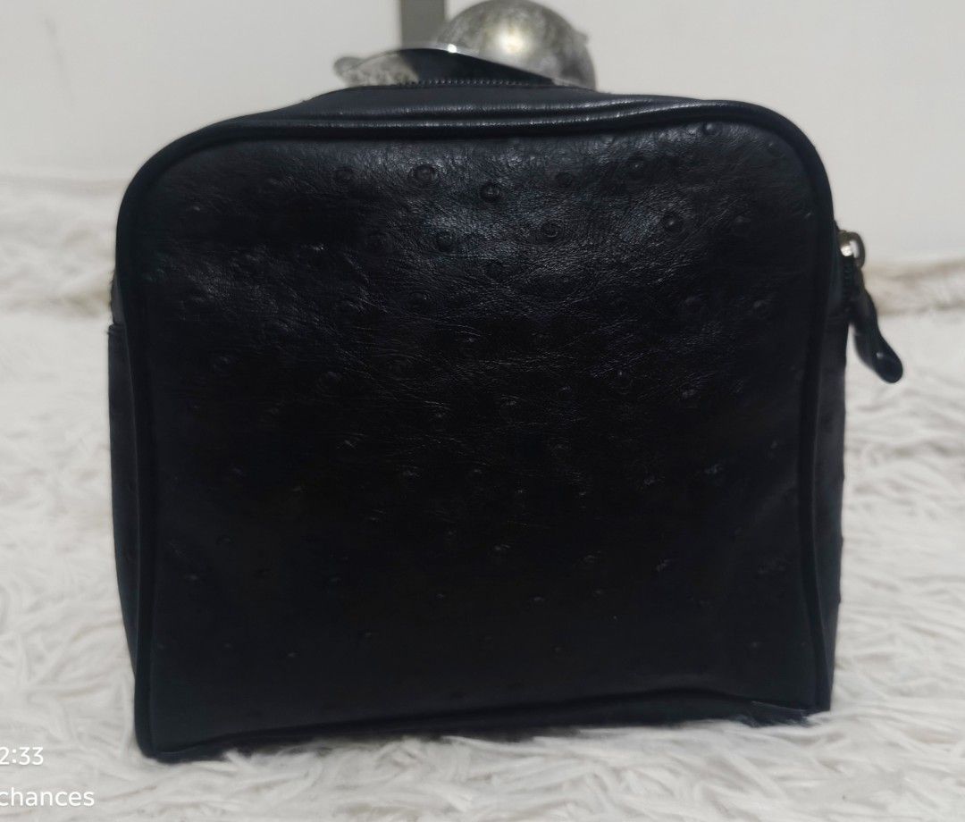 STEFANIA BINDI FIRENZE O STRICH- EMBOSSED COSMETIC POUCH (Category: Purses & Pouches) located in Kalibo. Submitted by secondchances.thriftsh8p (Listing ID 1470313138, Image 3). Description: - Material: Black leather with a stylish ostrich-style texture - Branding: Round embossed 'Italy by Friendi' logo stamp on the front pocket - Storage: Convenient front zipper compartment and a secure main top zipper closure - Design: Structured square shape wi