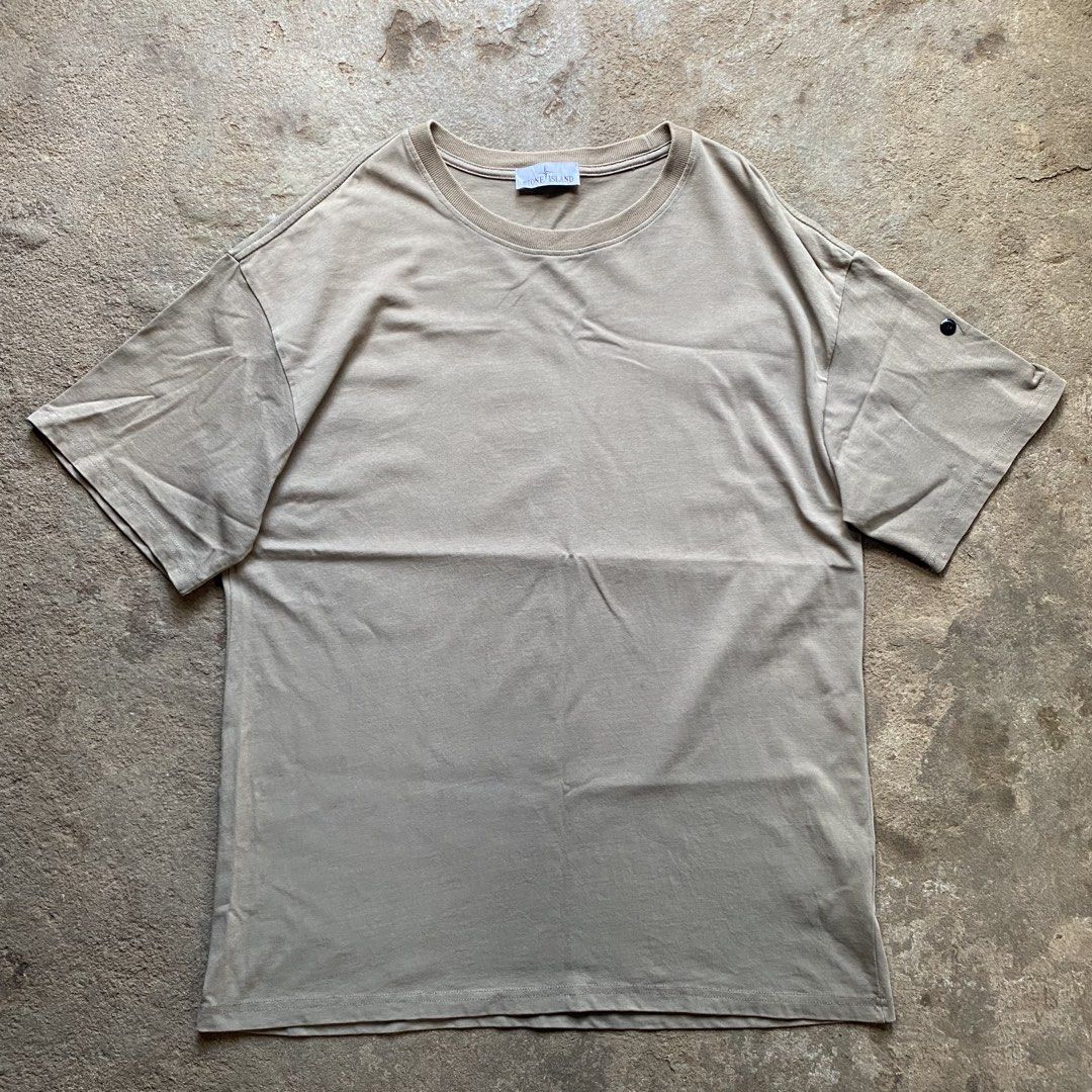 Stone Island T-Shirt Khaki (Category: Tshirts & Polo Shirts ) located in Tarlac. Submitted by pop_up_0 (Listing ID 1470204242, Image 1). Description: - Brand: Stone Island - Color: Khaki Grey - Dimes 22x27 - Style: Crewneck t-shirt with short sleeves - Details: Signature compass patch button on the left sleeve, ribbed collar, straight hem - Fit: Relaxed, oversized fit - Material: Soft cotton with a washed finish - .