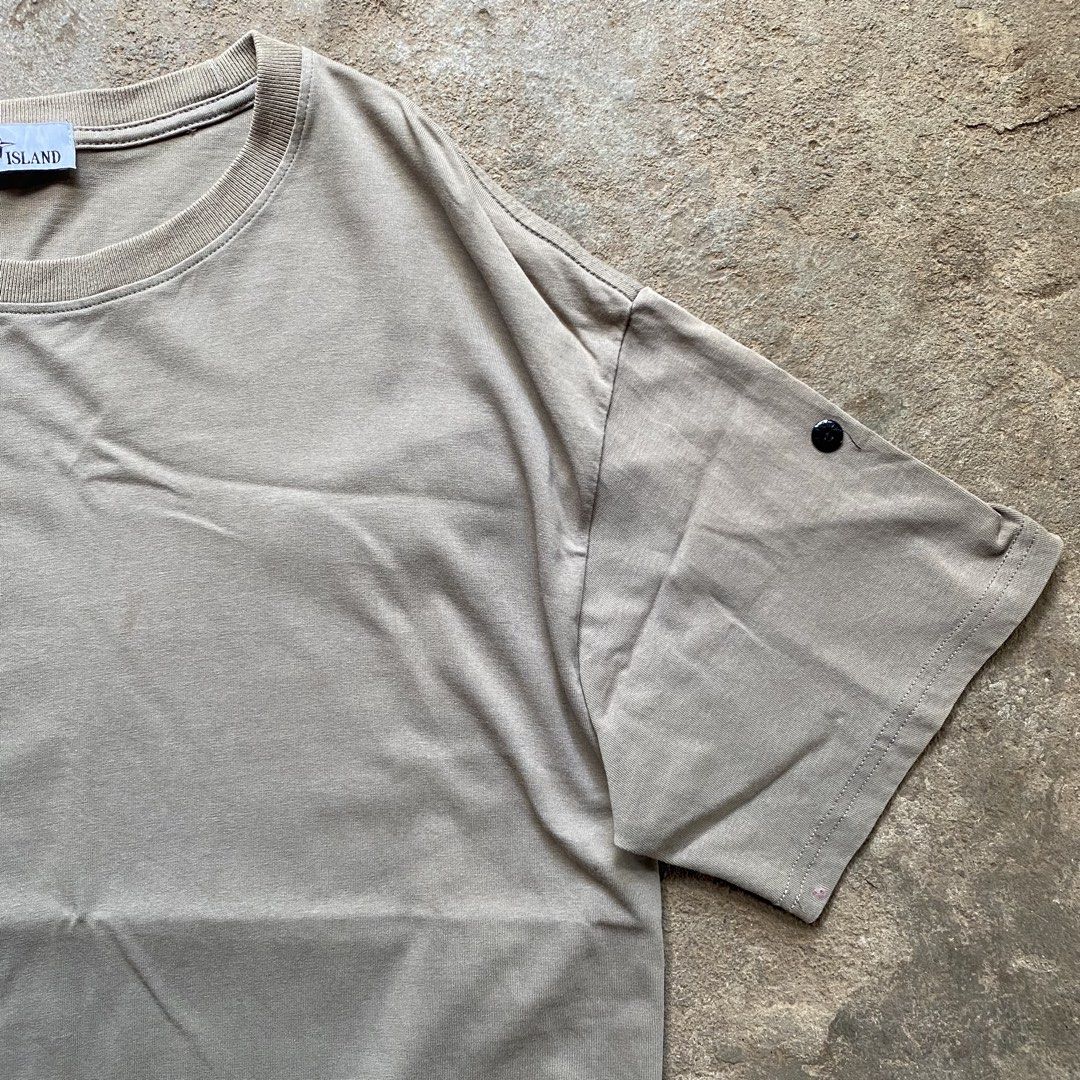 Stone Island T-Shirt Khaki (Category: Tshirts & Polo Shirts ) located in Tarlac. Submitted by pop_up_0 (Listing ID 1470204242, Image 3). Description: - Brand: Stone Island - Color: Khaki Grey - Dimes 22x27 - Style: Crewneck t-shirt with short sleeves - Details: Signature compass patch button on the left sleeve, ribbed collar, straight hem - Fit: Relaxed, oversized fit - Material: Soft cotton with a washed finish - .