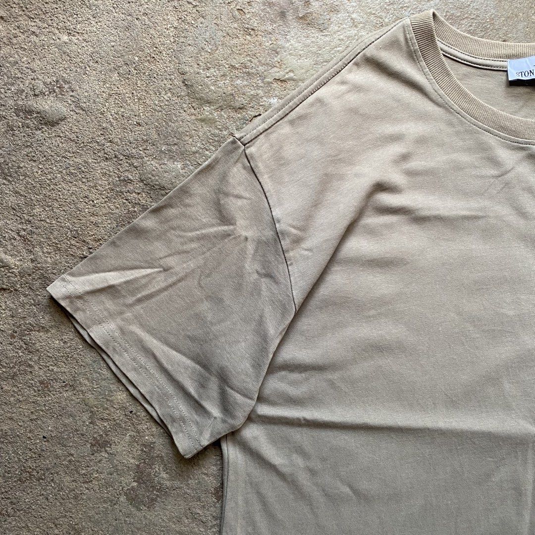 Stone Island T-Shirt Khaki (Category: Tshirts & Polo Shirts ) located in Tarlac. Submitted by pop_up_0 (Listing ID 1470204242, Image 2). Description: - Brand: Stone Island - Color: Khaki Grey - Dimes 22x27 - Style: Crewneck t-shirt with short sleeves - Details: Signature compass patch button on the left sleeve, ribbed collar, straight hem - Fit: Relaxed, oversized fit - Material: Soft cotton with a washed finish - .