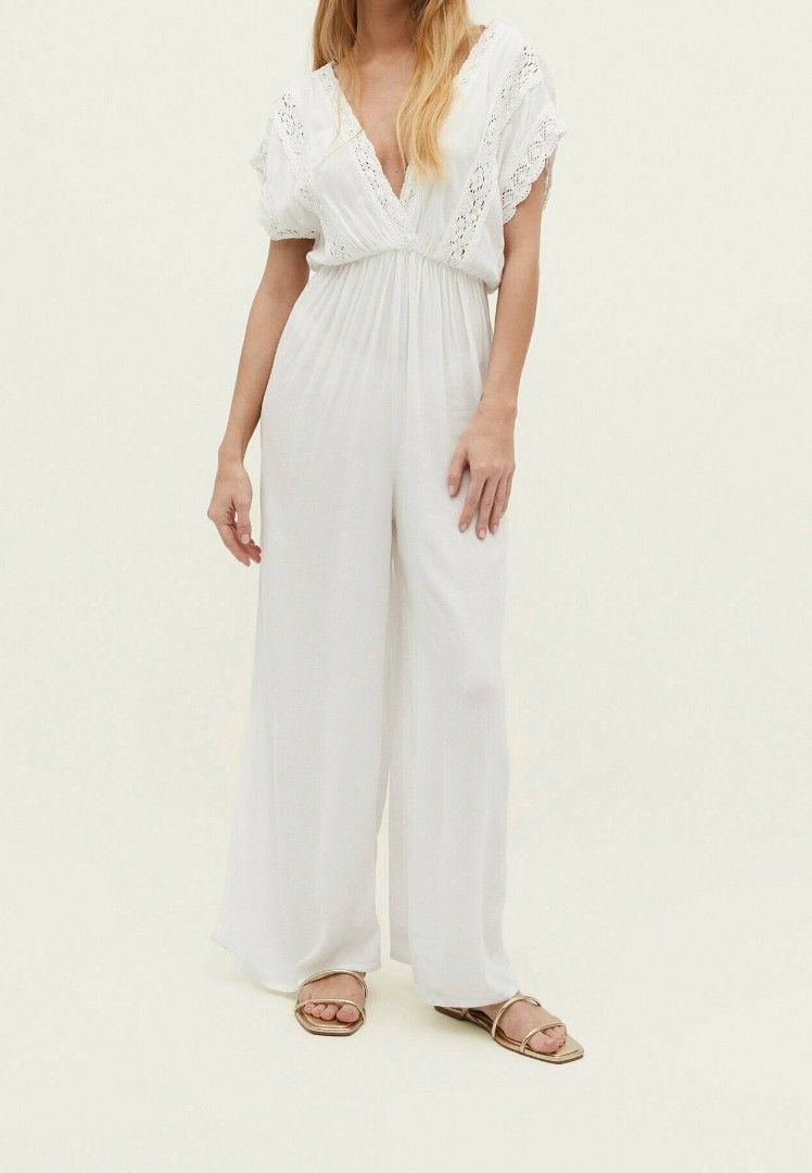 Stradivarius White Lace Trim Jumpsuit (Category: Jumpsuits) located in Taguig. Submitted by ashie_clothing (Listing ID 1470287101, Image 1). Description: - Brand: Stradivarius - Size: M - Color: White - Design: V-neck with delicate lace trim on neckline and sleeves - Fit: Relaxed fit with a trendy wide-leg cut - Condition: Brand new with tags (BNWT) - Original Price: ₱2,795 - Origin: Made in India.