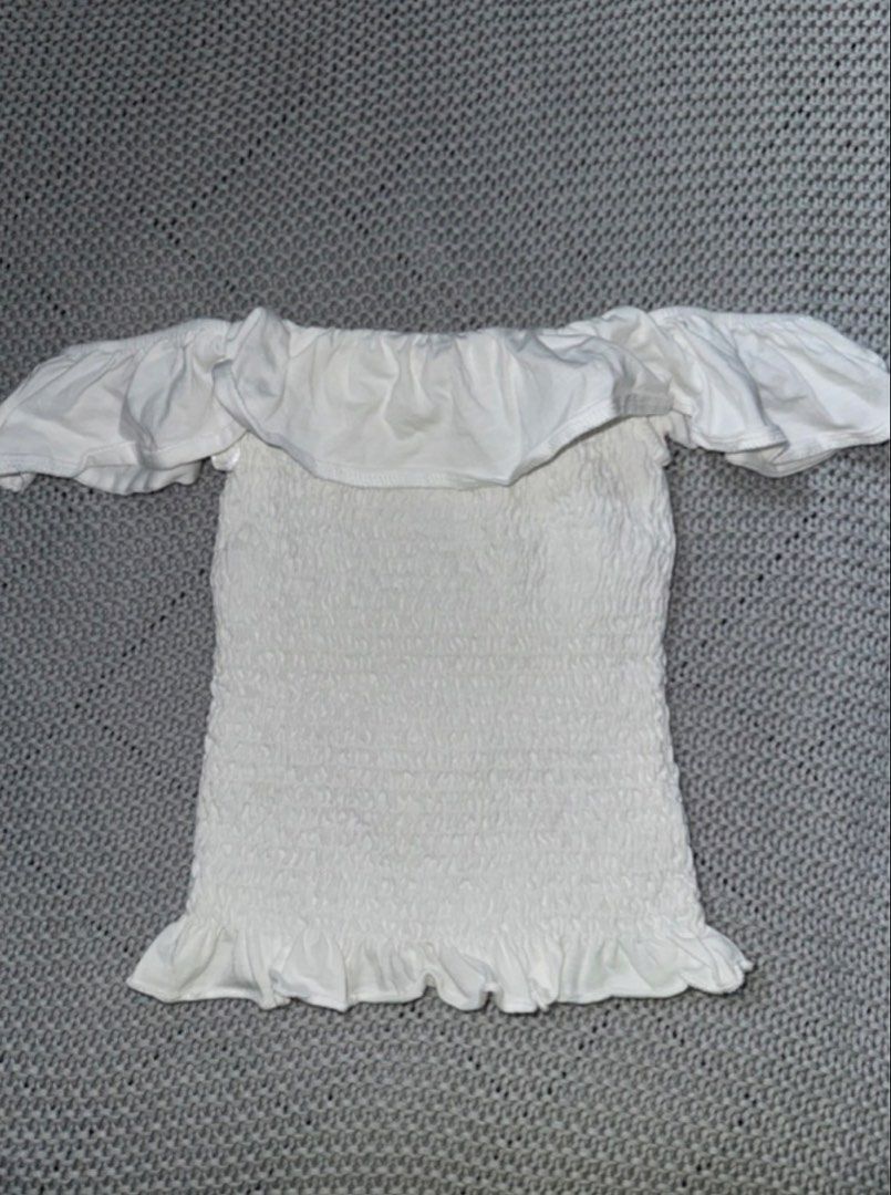 Stradivarius white off-shoulder top (Category: Others Tops) located in Manila. Submitted by danse.ph (Listing ID 1470335453, Image 1). Description: size: XS rfs: too small, never worn -white off-shoulder smocked crop top with ruffled details and short sleeves.