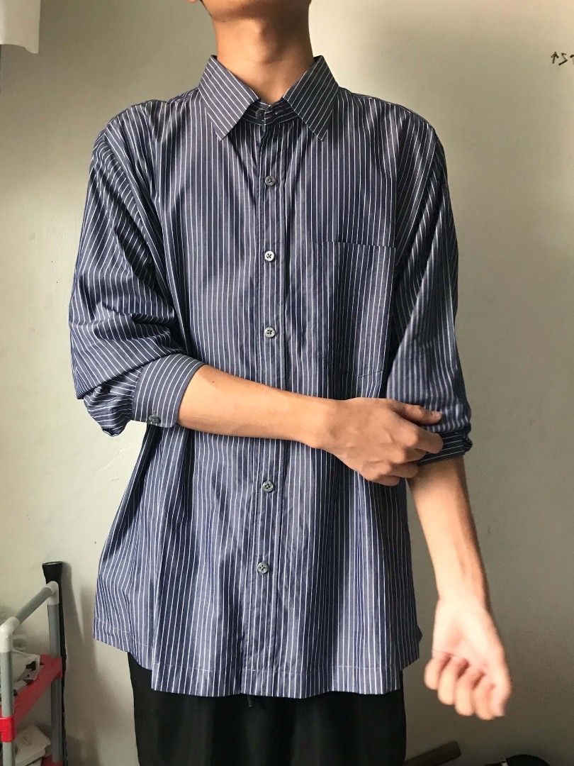 Striped Long-Sleeve Button-Down Shirt 🖤🤍 (Category: Tshirts & Polo Shirts ) located in Paranaque City. Submitted by genxie_ (Listing ID 1470209546, Image 2). Description: Striped Long-Sleeve Button-Down Shirt 🖤🤍 - Color: Dark gray/navy with white vertical stripes - No brand / no tags - Condition: Good condition - No fading or discoloration - Long sleeves with striped cuffs - With front pocket - Classic collar and button-down design Measuremen