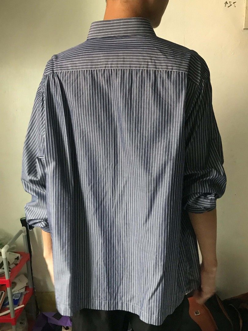 Striped Long-Sleeve Button-Down Shirt 🖤🤍 (Category: Tshirts & Polo Shirts ) located in Paranaque City. Submitted by genxie_ (Listing ID 1470209546, Image 3). Description: Striped Long-Sleeve Button-Down Shirt 🖤🤍 - Color: Dark gray/navy with white vertical stripes - No brand / no tags - Condition: Good condition - No fading or discoloration - Long sleeves with striped cuffs - With front pocket - Classic collar and button-down design Measuremen
