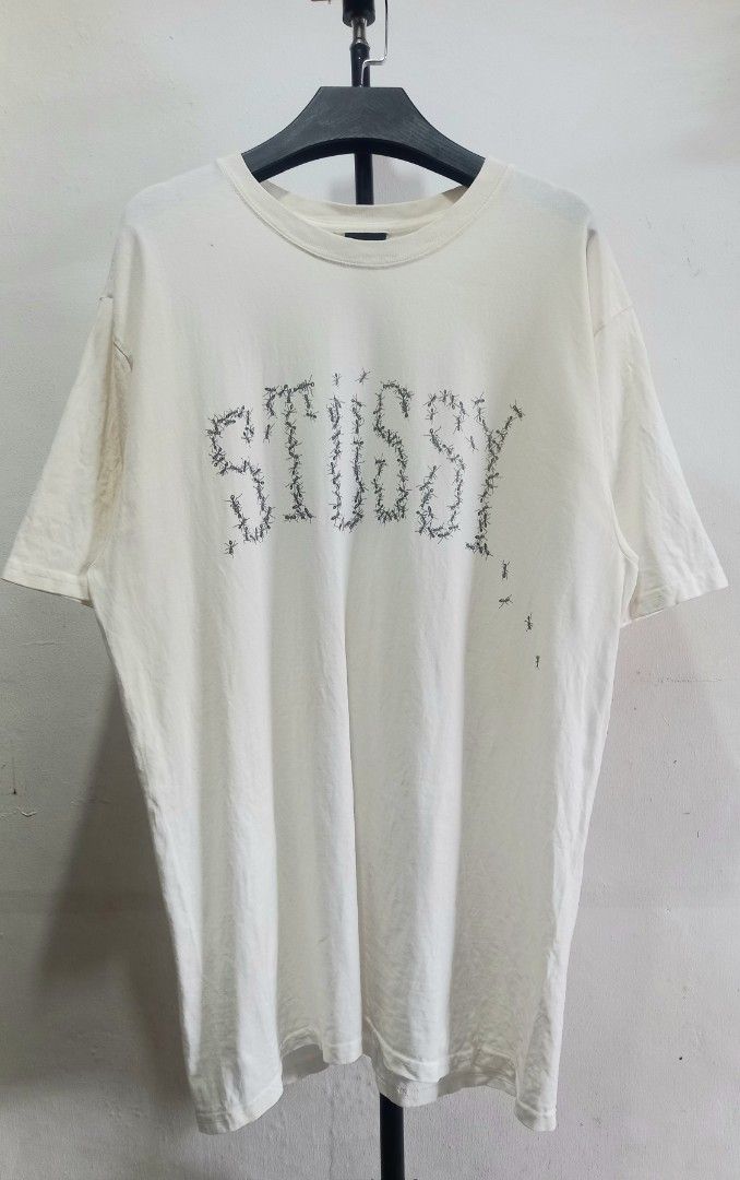 Stussy Ant Graphic White Tee Size M (Category: Tshirts & Polo Shirts ) located in Tarlac. Submitted by den420 (Listing ID 1470220192, Image 2). Description: - Brand: Stussy - Style: Crewneck t-shirt with short sleeves and standard fit - Color: White - Size: M (tag attached) - Material: 100% cotton, made in Guatemala - Design: Unique ant graphic spelling the Stussy logo on the front and a swirl design on the back - Condition: Like new with tags.