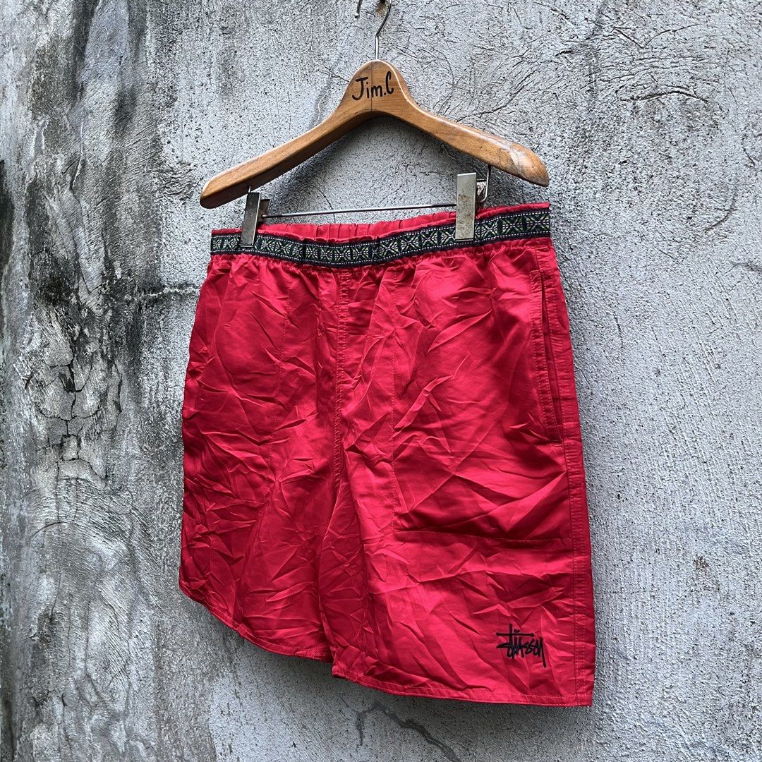 Stussy Red Nylon Shorts Size M (Category: Shorts) located in Davao. Submitted by streetsight (Listing ID 1470298681, Image 1). Description: - Brand: Stussy - Color: Bright Red - Size: Medium (M) - Material: Lightweight nylon, ideal for casual wear - Waistband: Elastic with stylish patterned trim detail - Branding: Small embroidered signature logo near hem and Stussy-embossed metal eyelets - Condition: Brand new with inner tags attached.