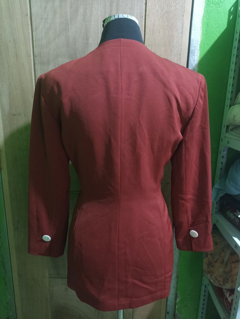 Sun Rose vintage rust orange blazer jacket with white buttons (Category: Coats, Jackets and Outerwear) located in Tarlac. Submitted by allinoneshop2178 (Listing ID 1470252400, Image 3). Description: - Brand: Sun Rose - Color: Rust orange - Style: Collarless with notched front cutout and tailored waist - Details: Four white textured buttons, matching cuff button details - Pockets: Two slanted front pockets - Lining: Fully lined in matching orange 