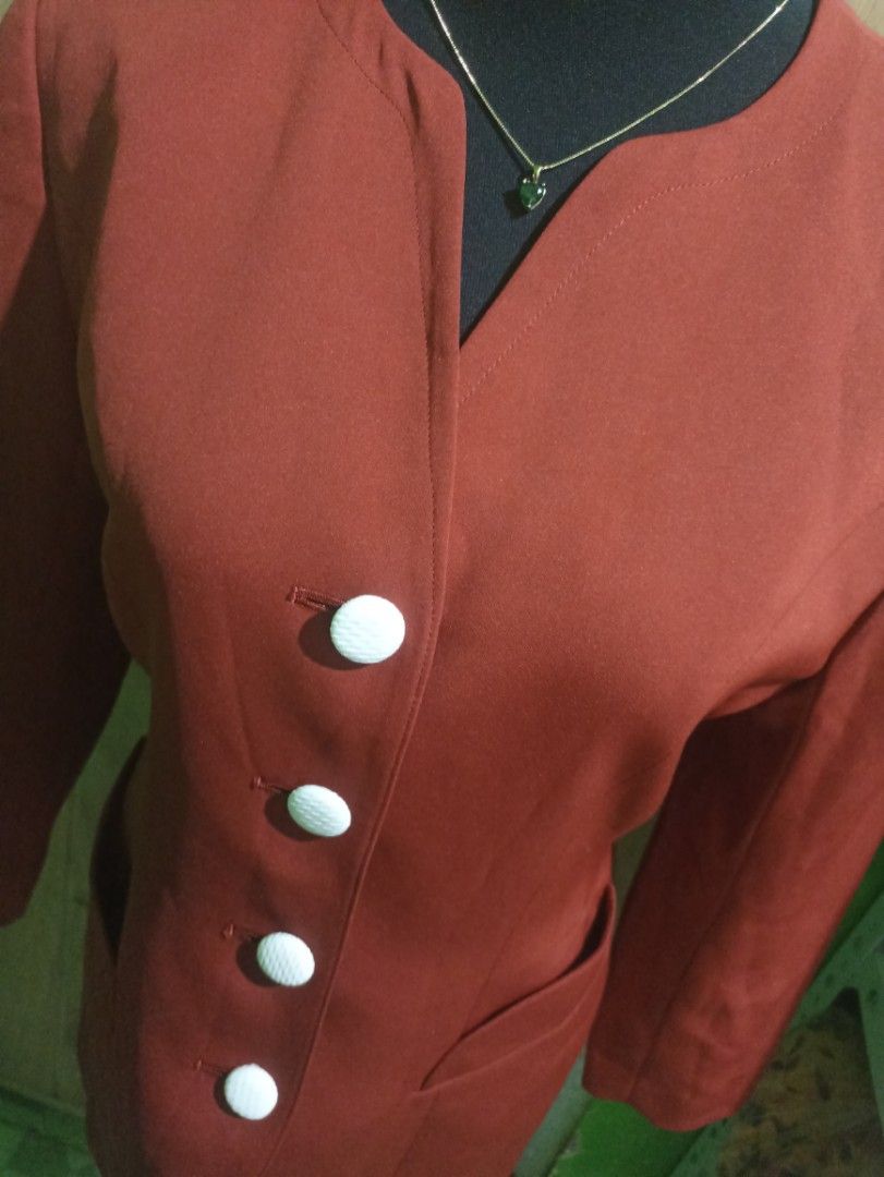 Sun Rose vintage rust orange blazer jacket with white buttons (Category: Coats, Jackets and Outerwear) located in Tarlac. Submitted by allinoneshop2178 (Listing ID 1470252400, Image 2). Description: - Brand: Sun Rose - Color: Rust orange - Style: Collarless with notched front cutout and tailored waist - Details: Four white textured buttons, matching cuff button details - Pockets: Two slanted front pockets - Lining: Fully lined in matching orange 