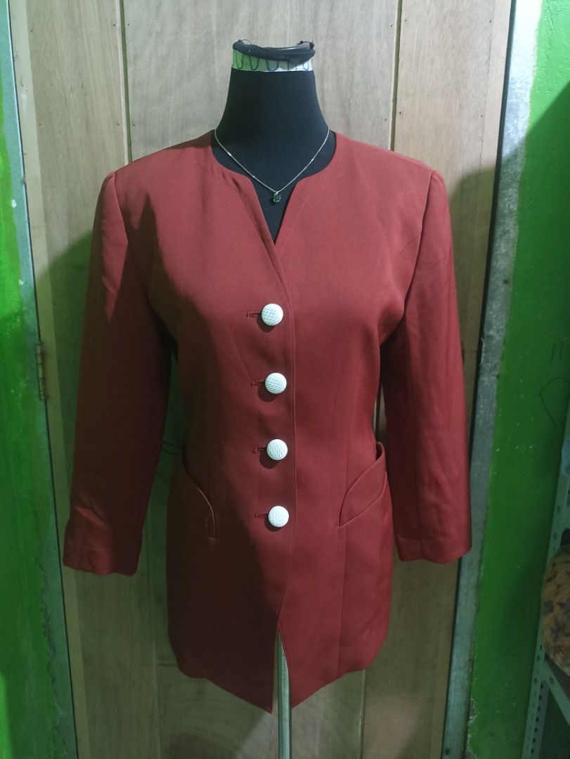 Sun Rose vintage rust orange blazer jacket with white buttons (Category: Coats, Jackets and Outerwear) located in Tarlac. Submitted by allinoneshop2178 (Listing ID 1470252400, Image 1). Description: - Brand: Sun Rose - Color: Rust orange - Style: Collarless with notched front cutout and tailored waist - Details: Four white textured buttons, matching cuff button details - Pockets: Two slanted front pockets - Lining: Fully lined in matching orange 