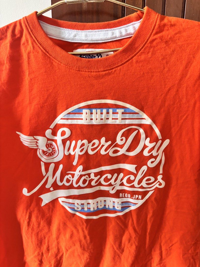 Superdry Orange Shirt (Category: Tshirts & Polo Shirts ) located in Manila. Submitted by minieiv._ (Listing ID 1470211404, Image 2). Description: * Pre-loved * Bought in Singapore * RFS: Decluttering * Meetup: Puregold San Mateo, Ampid Mercury.