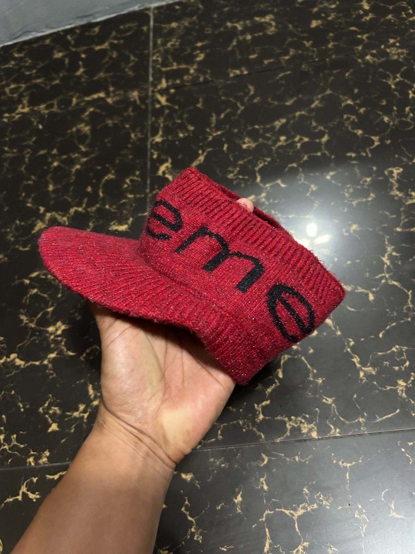 Supreme Red Knit Visor Cap (Category: Caps & Hats) located in Manila. Submitted by marjoriete27817 (Listing ID 1470310504, Image 3). Description: - Brand: Supreme - Style: Red knit visor cap / open top - Details: Black Supreme branding across the front, textured knit fabric, curved brim - Condition: Carefully stored, excellent for casual streetwear looks - Meetup/Shipping available across the Philippines.