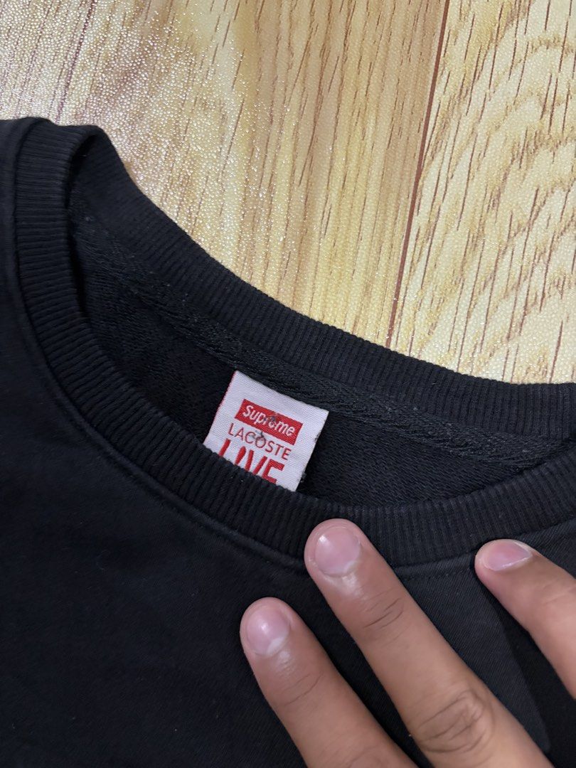 Supreme x Lacoste Live Black Sweatshirt (Category: Coats, Jackets and Outerwear) located in Caloocan City. Submitted by jerichotad22965 (Listing ID 1470194622, Image 3). Description: - Authentic Supreme x Lacoste Live black crewneck sweatshirt - Features embossed Supreme lettering across the chest - Detailed with Lacoste Sportif Paris embroidery and classic crocodile patch - Red branded collar tags and interior wash label intact - Material: 100% 