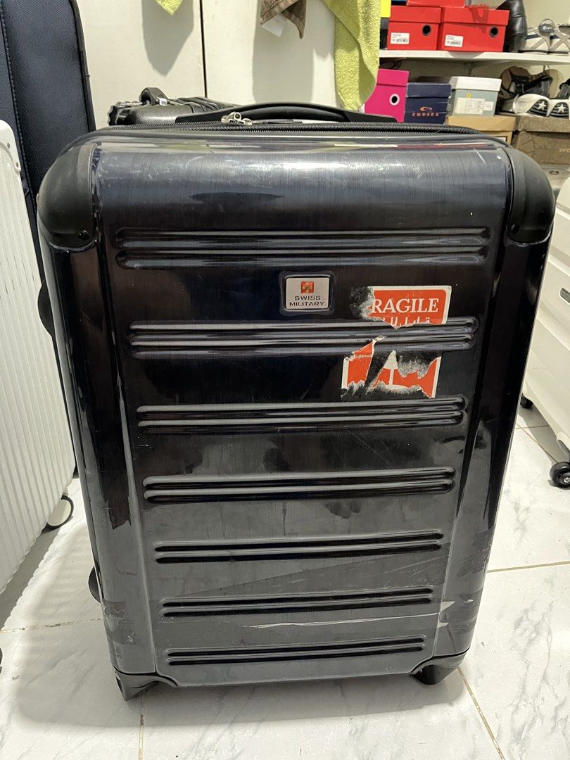 Swiss military luggage (Category: Luggage) located in Marikina City. Submitted by patpatndls (Listing ID 1470323450, Image 1). Description: - Brand: Swiss Military - Type: Hardcase Luggage / Medium Size (approx. 23-24 inches) - Color: Dark Blue / Black - Condition: 7/10 (shows minor exterior scuffs/stickers from travel, zippers and wheels work great, interior is clean) - Features: Durable hardshell exterior, secure inner cross straps, multiple zi