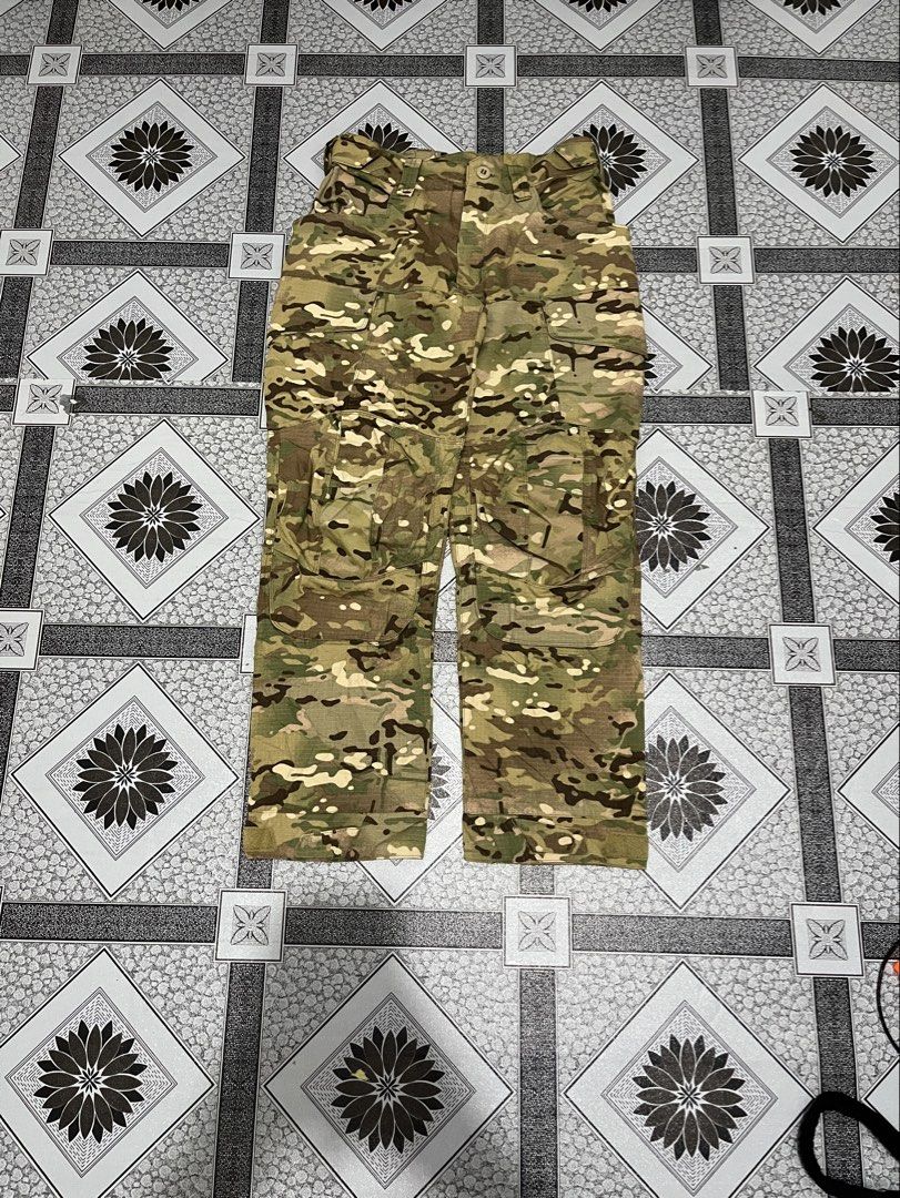 Tactical Series Multicam Camouflage Cargo Pants (Category: Jeans) located in Quezon City. Submitted by flip_da_cash (Listing ID 1470156286, Image 1). Description: - Size: XL (labeled at inner waistband) Waist: 34 Length: 39 Hem: 10 - Pattern: Multicam camouflage - Material: Durable ripstop fabric for long-lasting wear - Pockets: Multiple utility cargo pockets and back flap pockets with reinforced construction - Closure: Waistband with belt loops 