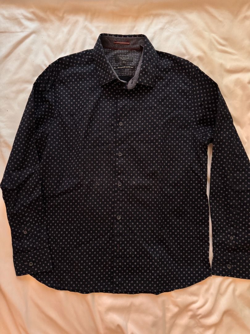 Ted Baker London geometric print button-down shirt Large (Category: Blouses) located in Cebu City. Submitted by _t.rix (Listing ID 1470186662, Image 1). Description: - Brand: Ted Baker London - Style: Men's long-sleeve button-down shirt - Color/Pattern: Dark navy blue with all-over white geometric print - Size: Tagged Size 5 (Large) - Material: 98% cotton, 2% elastane (slight stretch for comfort) - Details: Contrasting inner collar/trim with red 