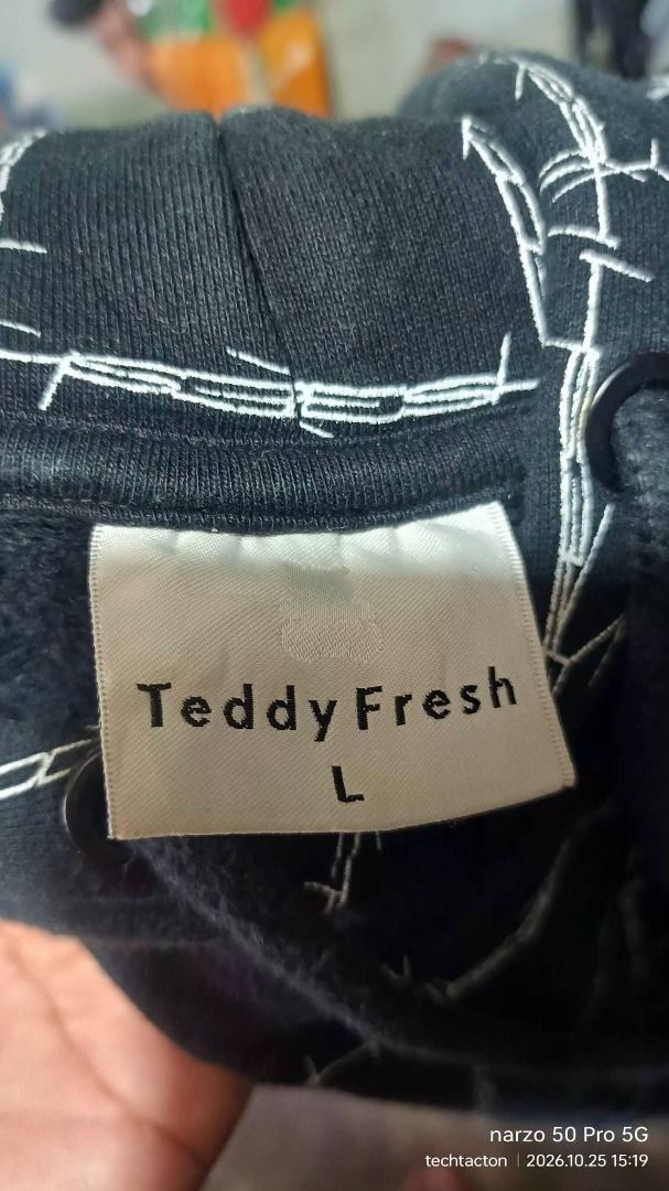 Teddy Fresh Black Barbed Wire Grid Hoodie (Category: Coats, Jackets and Outerwear) located in Santo Tomas. Submitted by pickers_corner (Listing ID 1470293873, Image 3). Description: TEDDY FRESH barbed wire grid Hoodie size L dime 23x28 excellent condition no issue - Brand: Teddy Fresh - Color: Black with white barbed wire grid pattern - Size: Large - Details: Embroidered red bear logo on left chest, drawstring hood with knotted cords - Material: 