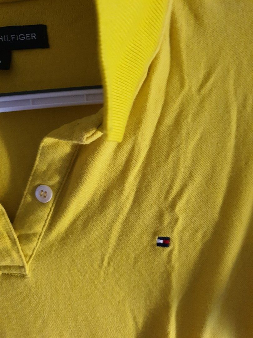 TH Yellow Polo Shirt Size L (Category: Tshirts & Polo Shirts ) located in Paranaque City. Submitted by love_opaque (Listing ID 1470229676, Image 3). Description: - Brand: TH -Auth Not Guaranteed - Color: Bright Yellow - Size: L (Tag inside collar) - Material: Comfortable cotton fabric - Design: Classic button placket with white buttons, ribbed collar and sleeve cuffs - Details: Small embroidered Tommy logo flag on the chest - Style: Casual short 