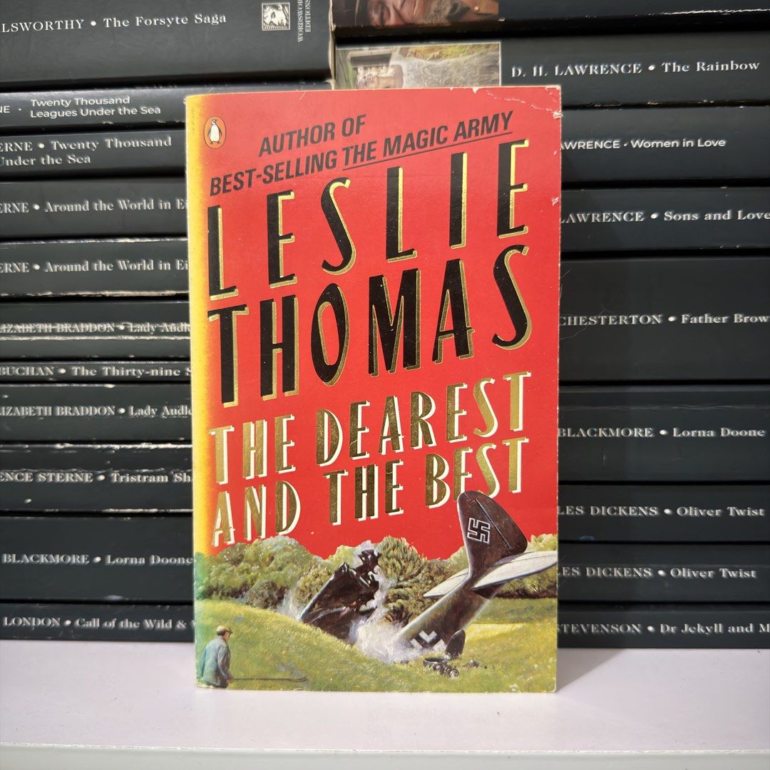 The Dearest and the Best by Leslie Thomas paperback (Category: Storybooks) located in Lingayen. Submitted by readwjane (Listing ID 1470199287, Image 1). Description: - Title/Author: Classic paperback novel by Leslie Thomas (author of The Magic Army) - Publisher: Penguin publication - Cover Art: Striking red design featuring a crashed aircraft with a swastika emblem and a green countryside illustration - Genre: Classic fiction read - Condition: Pr