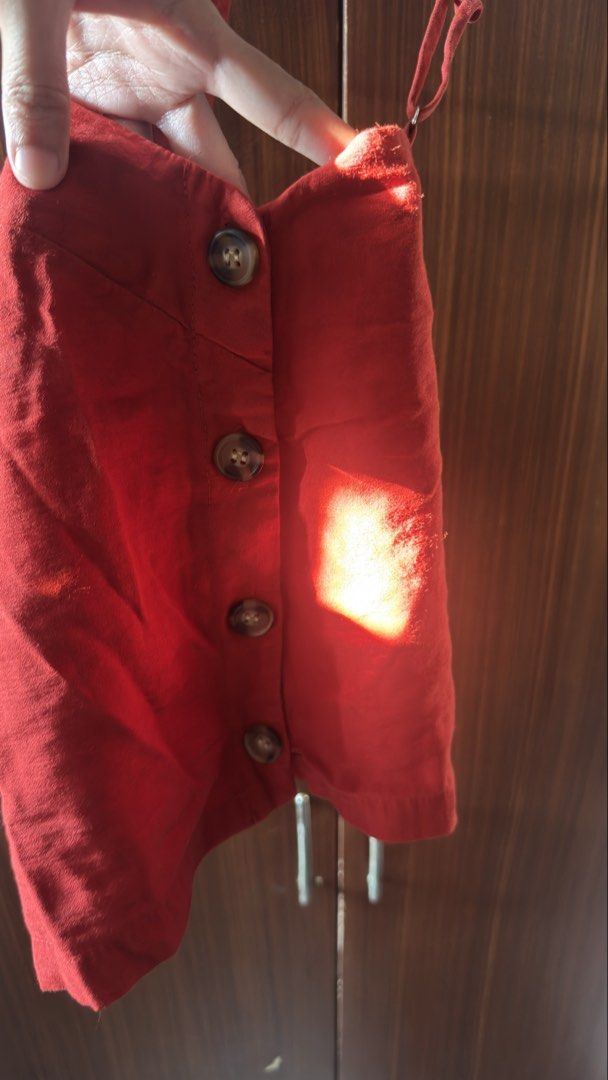 The Editor's Market Top (Category: Sleeveless) located in Las Pinas. Submitted by crlne (Listing ID 1470230733, Image 2). Description: - Brand: The Editor's Market - Size: XS - Color: Red - Design: Square neckline, thin adjustable straps, and side button placket with four brown buttons - Fabric: Lightweight, ideal for warm weather or layering - Condition: Minor wear near the arm opening, otherwise clean and ready to wear.