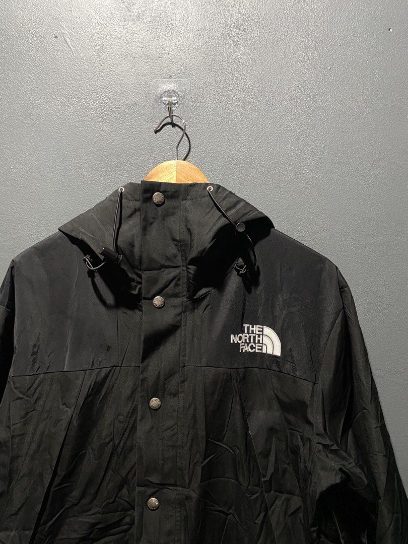 The North Face Black Gore-Tex Waterproof Jacket (Category: Coats, Jackets and Outerwear) located in Lucena. Submitted by handpickthrift (Listing ID 1470183309, Image 3). Description: - Brand: The North Face - Color: Black 22x26 dimes - Material: Gore-Tex (100% waterproof for heavy rain) - Closure: Full zip front with snap button storm flap - Hood: Adjustable with drawstrings - Cuffs: Adjustable Velcro straps - Branding: Embroidered logo on front 
