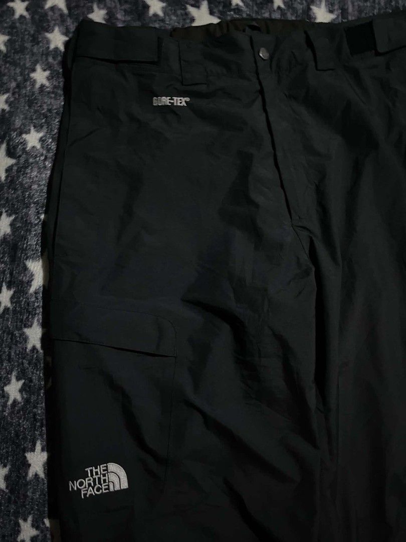 The North Face Gore-Tex Black Snow Pants (Category: Trousers) located in Manila. Submitted by ja_thrift. (Listing ID 1470195509, Image 3). Description: - Brand: The North Face - Style: Waterproof Gore-Tex snow pants - Color: Solid black - Size: Medium - Country of Origin: Bangladesh - Material: 100% nylon shell with Gore-Tex ePTFE membrane and polyester lining - Closure: Button closure with zip fly - Pockets: Front cargo pocket with pull cord - D