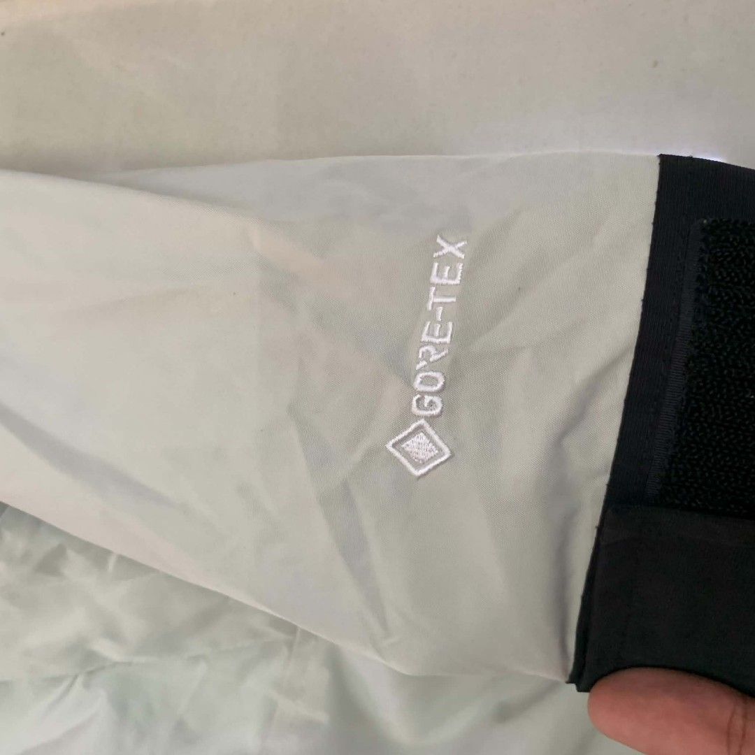 The North Face GORE-TEX Mountain Jacket (Category: Coats, Jackets and Outerwear) located in Manila. Submitted by michaelge38472 (Listing ID 1470166144, Image 2). Description: - Brand: The North Face - Material: Genuine waterproof GORE-TEX fabric - Color: Light grey and black - Features: Adjustable hood, snap button front closure, and velcro sleeve cuffs - Authenticity: Interior care tags and QR code attached - Best for: Outdoor trips, hiking, and